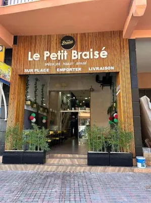 a store front of a restaurant with potted plants in front at Appartement calme, proche de toutes commodités in Marrakech