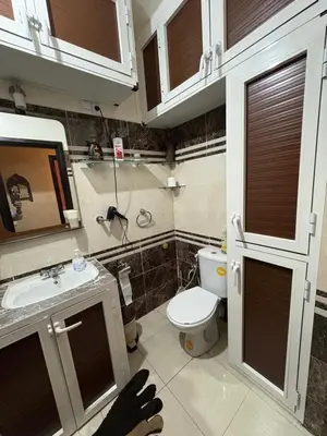 a small bathroom with a toilet and a sink at Family flat in Marrakech in Marrakech