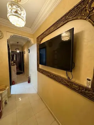 a flat screen tv on a wall in a hallway at Family flat in Marrakech in Marrakech