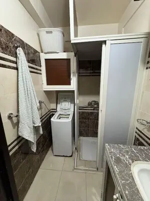 a small bathroom with a washer and dryer at Family flat in Marrakech in Marrakech