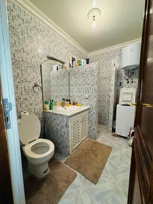 a bathroom with a toilet and a sink at B and b in our house in Marrakech