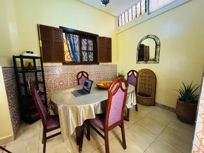 a dining room with a table with a laptop on it at B and b in our house in Marrakech
