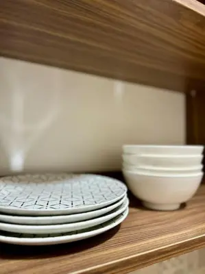 a stack of plates and bowls sitting on a shelf at Yumo - Cozy 2 in Marrakech