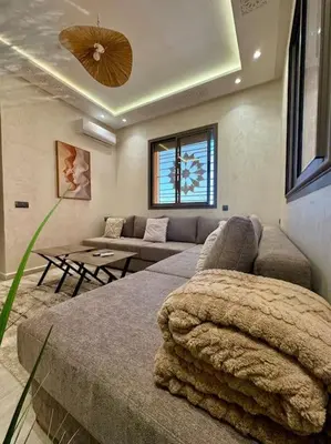 a living room with a couch and a living room with at Yumo - Cozy 2 in Marrakech