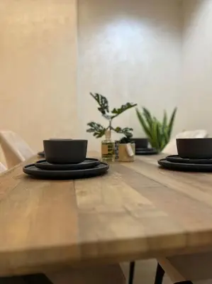 a wooden table with two cups on top of it at Yumo - La Vida in Marrakech