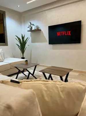 a living room with a couch and a tv at Yumo - La Vida in Marrakech