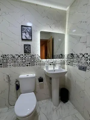 a white bathroom with a toilet and a sink at Yumo - La Vida in Marrakech