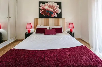 a bedroom with a large bed with a red rug at Zen & Chic - Marrakech Downtown in Marrakech