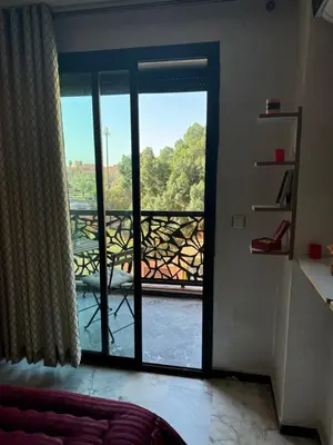 a room with a door open to a balcony at Heart of Marrakech city center - Gueliz in Marrakech