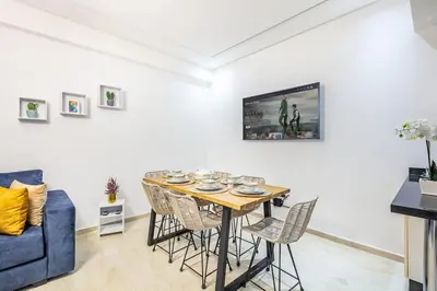 a dining room with a table and chairs at Appartement chic et moderne in Marrakech
