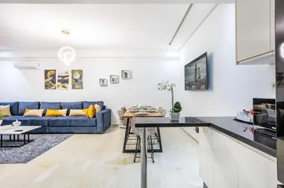 a living room with a blue couch and a table at Appartement chic et moderne in Marrakech