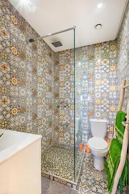 a bathroom with a toilet and a shower at Serene Oasis Pool & Garden View in Marrakech
