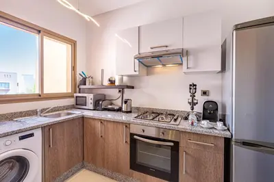 a kitchen with a sink and a stove top oven at Serene Oasis Pool & Garden View in Marrakech