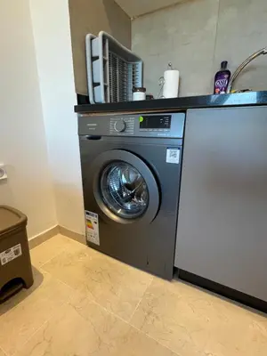 a washing machine in a kitchen with a sink at Cozy Urbain Appartement in Marrakech
