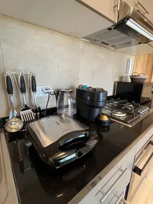 a kitchen with a counter top with a stove at Cozy Urbain Appartement in Marrakech