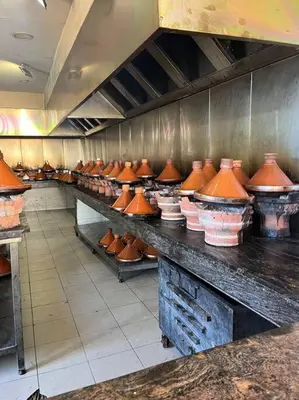 a kitchen filled with lots of copper vases at Cozy Urbain Appartement in Marrakech