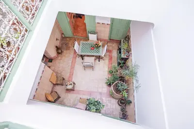 an overhead view of a patio with a table and plants at Riad Ghita Exclusif 15 min de Jemaa El Fnaa in Marrakech