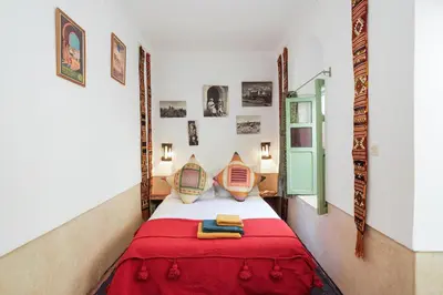 a bedroom with a bed with a red blanket at Riad Ghita Exclusif 15 min de Jemaa El Fnaa in Marrakech
