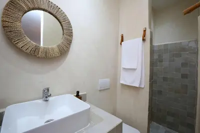 a bathroom with a white sink and a mirror at Riad Ouladi -Exclusif - 5mn Jemaa El Fnaa -Pool in Marrakech