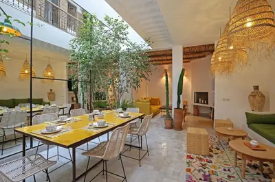 a dining room with a table and chairs at Riad Ouladi -Exclusif - 5mn Jemaa El Fnaa -Pool in Marrakech