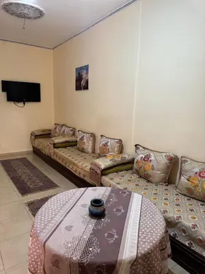 a living room with a couch and a table at TOP couple apartment in Marrakech