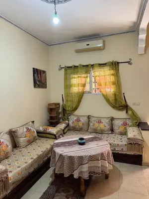 a living room with a couch and a table at TOP couple apartment in Marrakech