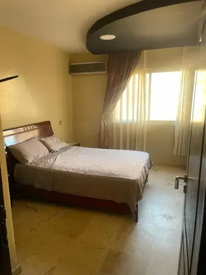 a bedroom with a bed next to a window at Appartement de Lux,Guèliz in Marrakech
