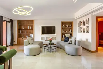 a living room with two couches and a tv at Appartement au cœur de Marrakech in Marrakech
