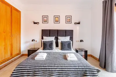 a bedroom with a large bed with blue and white sheets at Appartement au cœur de Marrakech in Marrakech