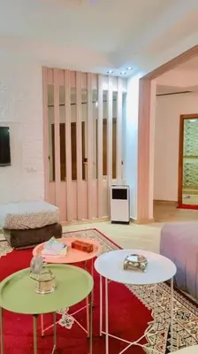 a living room with two tables and a couch at Spacieux Studio by Nina in Marrakech