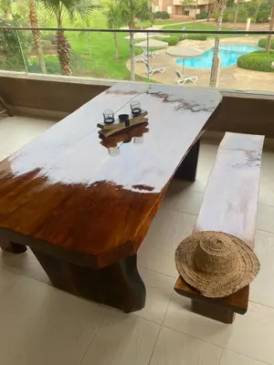 a wooden coffee table with a hat and a bench at GOLF PRESTIGIA Résidence TOPAZE in Marrakech