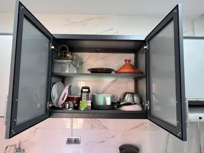 a cupboard filled with lots of kitchen items at Appartement familiale top one saada in Marrakech