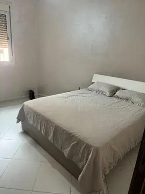 a white bedroom with a large bed in a room at EuroOriental house in Marrakech