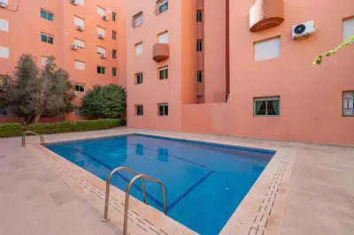 a swimming pool in front of a building at Appartement de luxe B5 1er in Marrakech