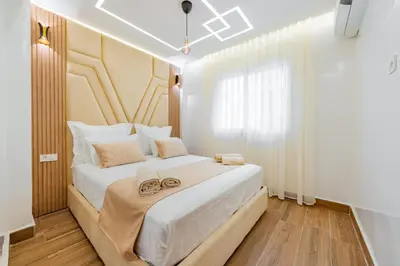 a bedroom with a large white bed with two shoes on it at Appartement de luxe B5 1er in Marrakech