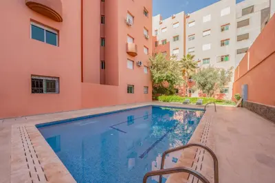 a swimming pool in the courtyard of a building at Appartement de luxe B5 1er in Marrakech