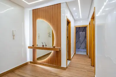 a hallway with a mirror and a wooden table at Appartement de luxe B5 1er in Marrakech
