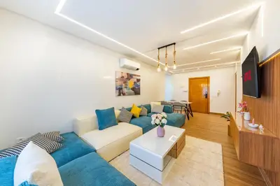 a living room with a couch and a table at VISTA HOLIDAYS Warda A31 in Marrakech