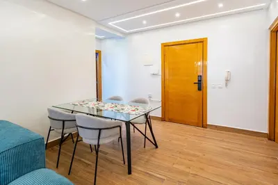 a dining room with a glass table and chairs at VISTA HOLIDAYS Warda A31 in Marrakech