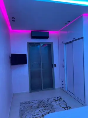 a room with two elevators and a purple light at Cosy et Agréable Appartement in Marrakech