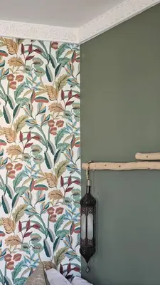 a lamp next to a wall with a floral wallpaper at Riad Clefs d'Orient in Marrakech