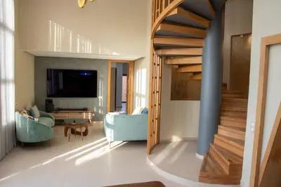 a staircase in a living room with a blue couch at Villa 