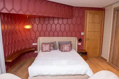 a bedroom with a bed with a red wall at Villa 