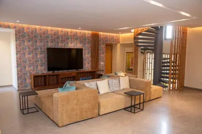 a living room with a couch and a flat screen tv at Villa 