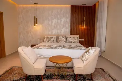 a bedroom with a bed and two chairs and a table at Villa 
