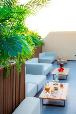 a room with couches and tables and plants at Residence Eden Marrakech in Marrakech