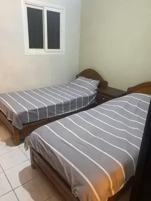 two beds sitting next to each other in a room at Riyad piscine intérieure privative in Marrakech
