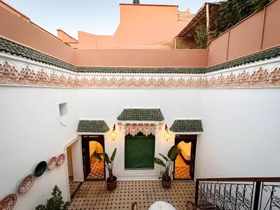 a balcony of a house with a green chalkboard at Riad M Azbetz in Marrakech