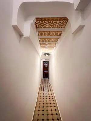 a hallway with a ceiling and a tile floor at Riad M Azbetz in Marrakech