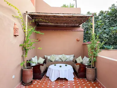 a small patio with a couch and a table at Riad M Azbetz in Marrakech